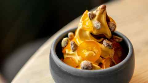 Rippled dark chocolate ice cream with frosted pistachios and candied kumquats at Noci in Islington
