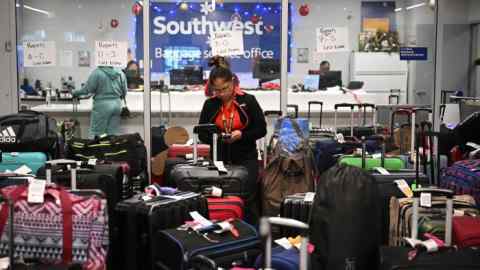 A Southwest Airlines ground crew member organises unclaimed luggage at Los Angeles International Airport last year