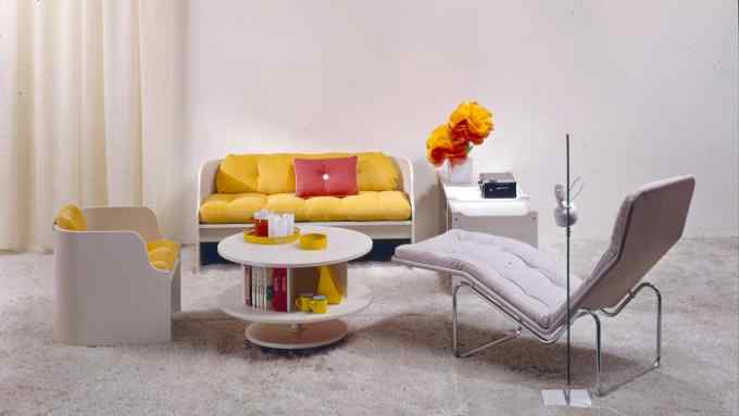 A sofa, chair and reclining chair in white with colourful cushions, designed by Ikea in 1969