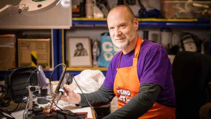 Dermot Jones, project manager at the Fixing Factory, sits at his workbench