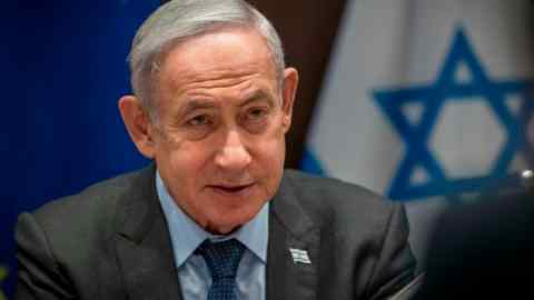 Close-up picture of Benjamin Netanyahu with an Israeli flag in the background