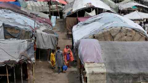Health workers visit a slum area in Lahore, Pakistan. Coronavirus is prompting a rethink about how cities in developing economies grow.