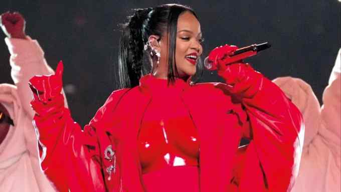 Rihanna performing in red outfit