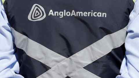 Logo of Anglo American is seen on a jacket of an employee of the Los Bronces copper mine