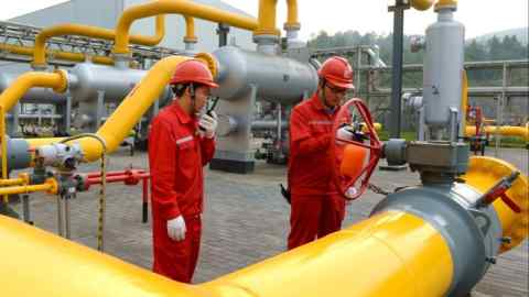 Workers inspect equipment at a shale gas field Chongqing