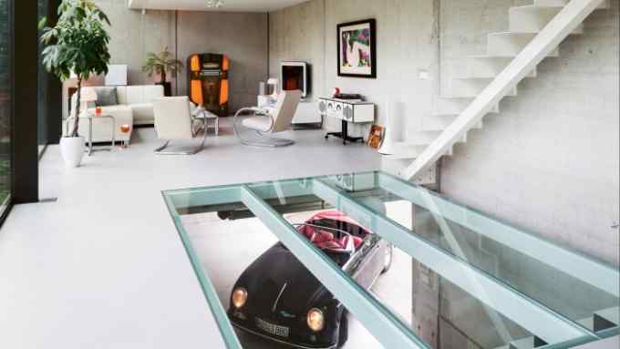 A replica Porsche 356 Speedster seen through the glass floor in the living room of a house in Belgium by Icoon.be Architecten, from the book Carchitecture by Thijs Demeulemeester, Thomas De Bruyne and Bert Voet, published by Lannoo Publishers at €39.99 (lannoopublishers.com)