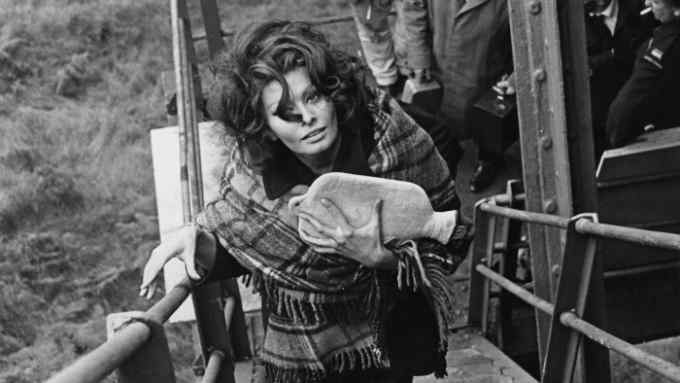 Sophia Loren with a hot-water bottle, on set in Wales, 1965