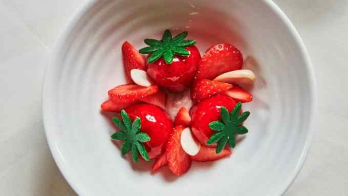 A bowl of strawberries with almonds and green marzipan stalks at Claridge’s