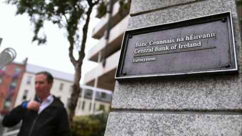 A man walks past the Central Bank of Ireland in Dublin