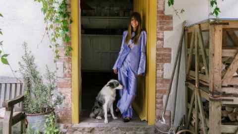 Fee Greening at home with her dog Patti. She wears a custom-made Spirit suit by Realms