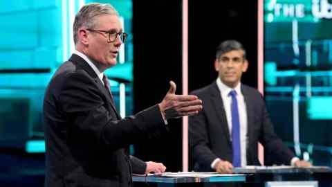 Sir Keir Starmer makes a point while Rishi Sunak looks on during the debate