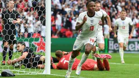 England’s Raheem Sterling wheels away after scoring his side’s opening goal against Germany at Wembley