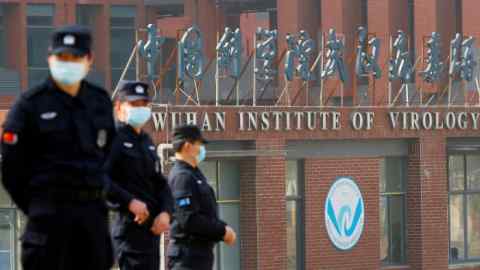 Security personnel keep watch outside the Wuhan Institute of Virology during a visit by the WHO February. US intelligence officials are currently investigating whether the facility could have played any role in the origins of Covid-19.