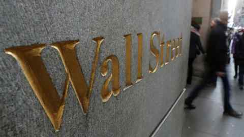 A street sign, Wall Street, is seen outside New York Stock Exchange