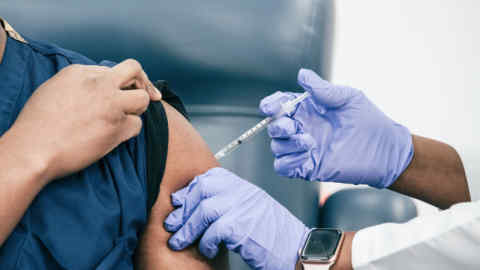 health worker injecting vaccine into an arm