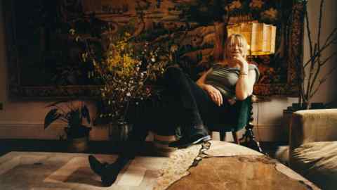 Courtney Love at home in London. On the wall behind her is a 17th-century Flemish verdure tapestry