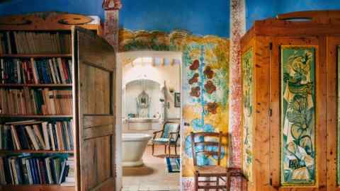 The master bedroom, with colourful frescoes and furniture painted by Gorky, looking into the bathroom