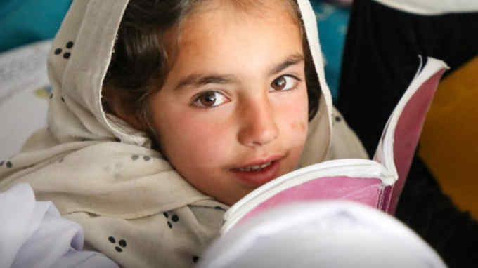 female Afghan child with a notebook