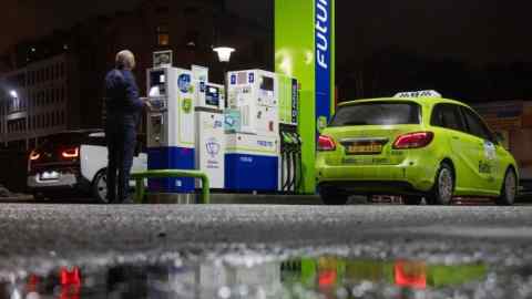 A customer pays at a fuel pump terminal on the forecourt of a Neste Oyj petrol station in Riga, Latvia