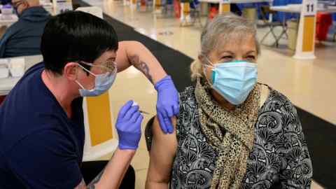 A healthcare worker administers a Covid vaccine to a woman in West Virginia