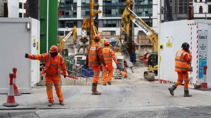 Construction workers are seen at a site entrance in London, following the outbreak of the coronavirus disease (COVID-19), London