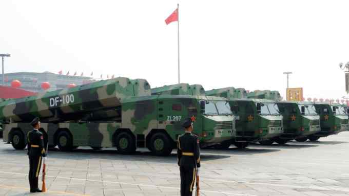 Military vehicles carrying hypersonic cruise missiles DF-100 drive past Tiananmen Square