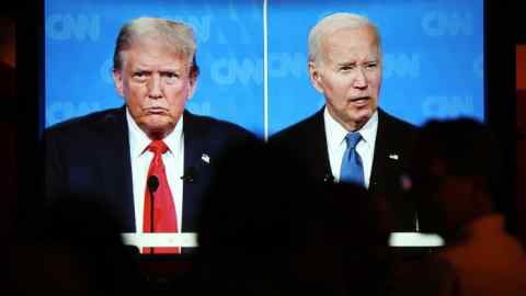 A TV screen shows Joe Biden, right, and Donald Trump during their first debate of 2024 on CNN