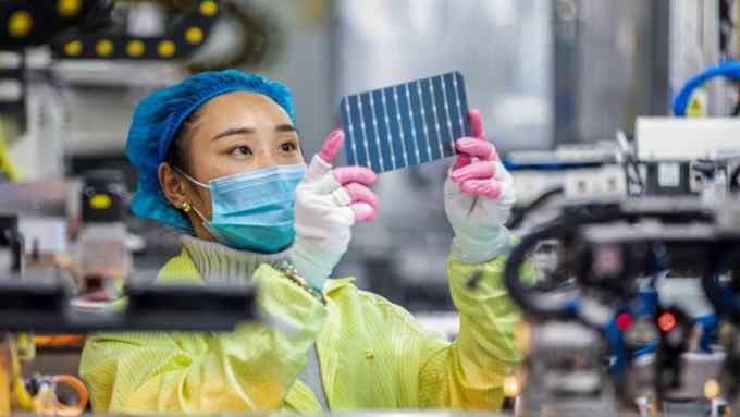 A worker checking solar photovoltaic modules used for small solar panels