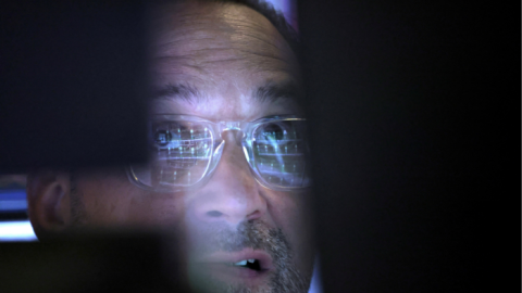 A trader looks at a screen at the New York Stock Exchange