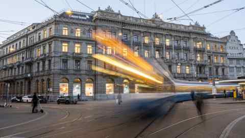 Long exposure shot of Credit Suisse headquarters in Zurich with blurred cars and street lights