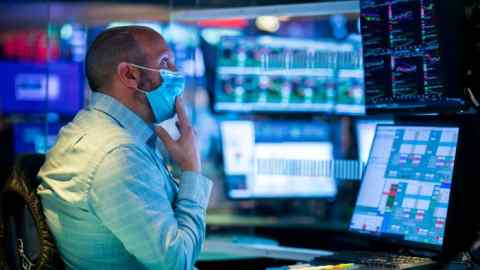 Specialist James Denaro works at his post on the trading floor of the New York Stock Exchange