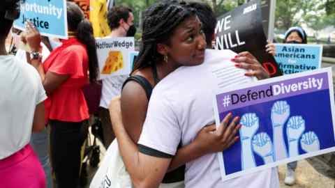 People embrace at a demonstration on the US Supreme Court’s decision to strike down race-conscious student admissions programs