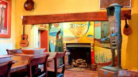 colourful painted mural around a fireplace