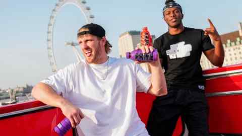 Logan Paul, left, and KSI, promote an energy drink on an open top bus travelling through London