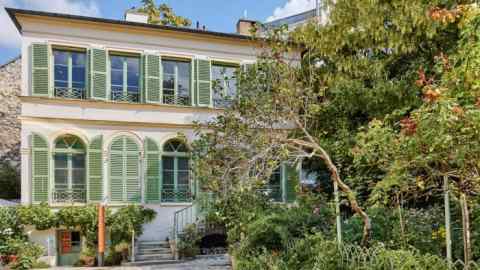 Italianate villa with green shutters and a garden
