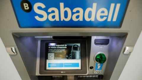 Sabadell’s logo on an ATM machine in Barcelona, Spain