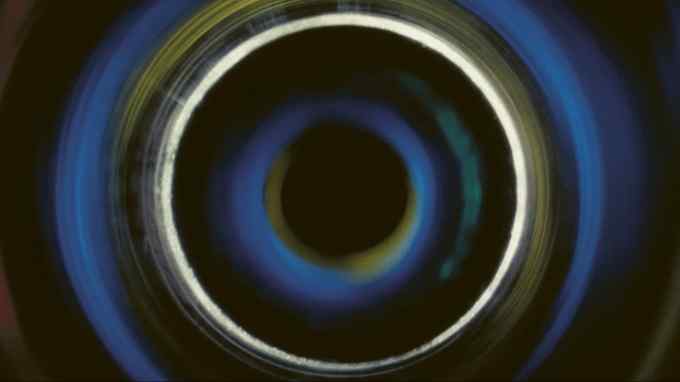 Concentric whirring circles of black, blue, yellow and thin white
