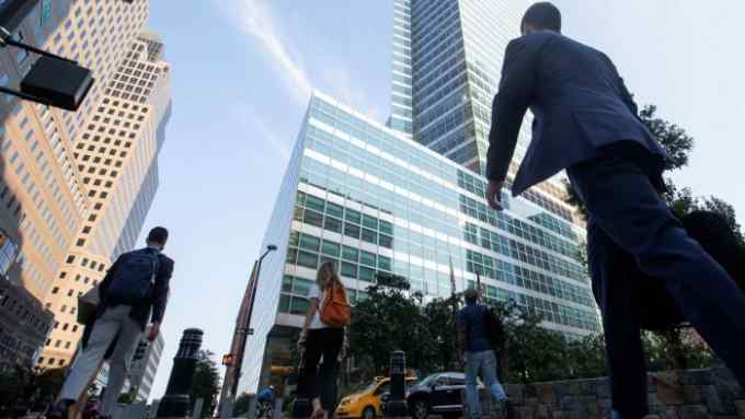 Office workers walk near the Goldman Sachs Group Inc. headquarters in New York, U.S.